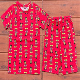 Red children's pajama set with MICKEY Mouse pattern on a wooden background